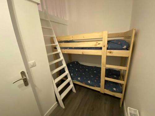 una habitación con dos literas y una escalera en Maison de plage, plain-pied, 3 chambres, en Colleville-Montgomery