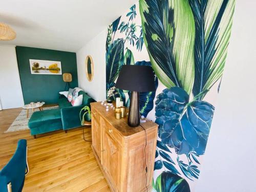 a living room with a couch and a lamp on a table at La canopée Abbeville baie de Somme in Abbeville