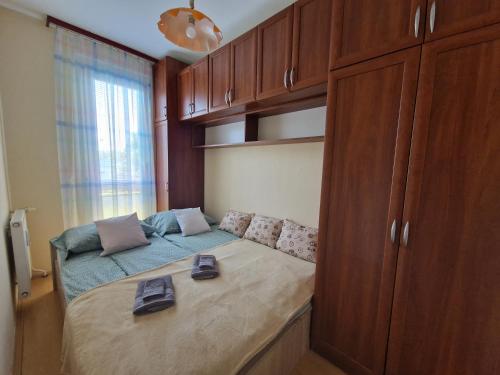 a small bedroom with a bed and a cabinet at Casa Cristina in Pécs