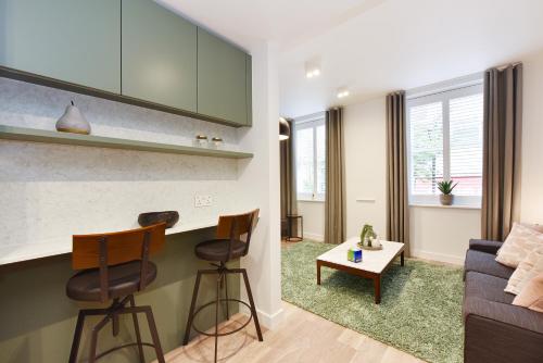 a living room with a couch and a table at James Street Serviced Apartments by Globe Apartments in London