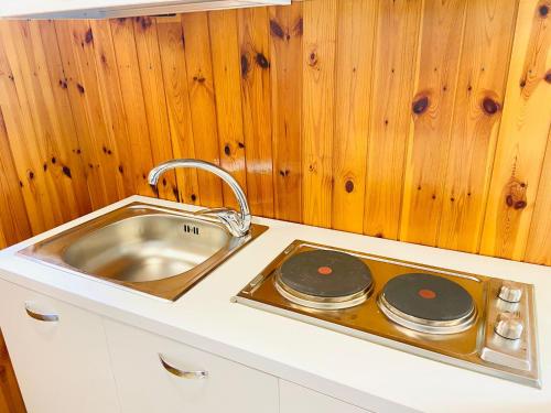 a kitchen with a sink and a stove at Casa Colomba in Anacapri