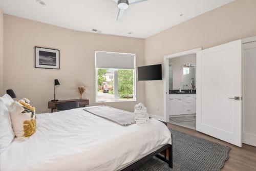 a bedroom with a large white bed and a window at Mason Lofts at West End in Nashville
