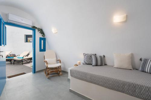 a bedroom with a bed and a table and chairs at Santorita Suites in Akrotiri