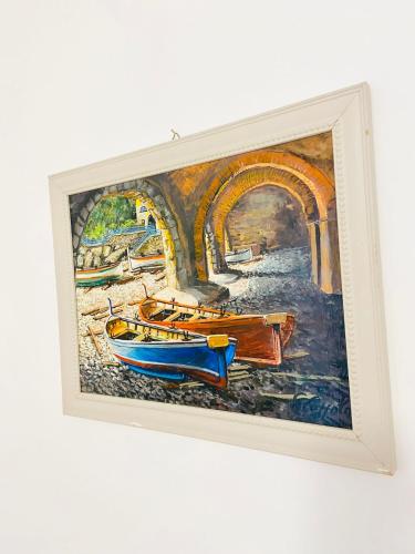 a painting of boats on the water with a bridge at Casa della Frutta in Anacapri