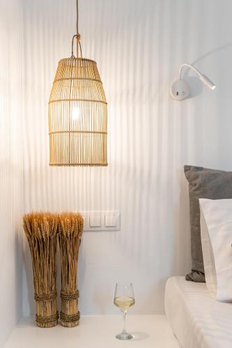 a bedroom with a bird cage and a wine glass at Naxos Anamnisi in Plaka