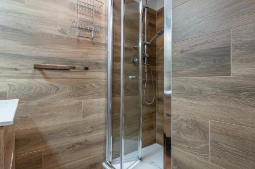 a shower with a glass door in a bathroom at GuestHost - Marilyn Apartment tra centro e mare in Pesaro
