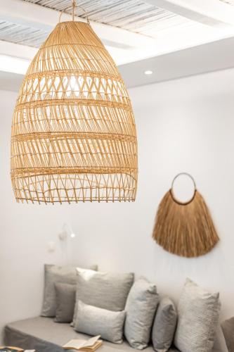 a living room with a couch and a hanging light at Naxos Anamnisi in Plaka
