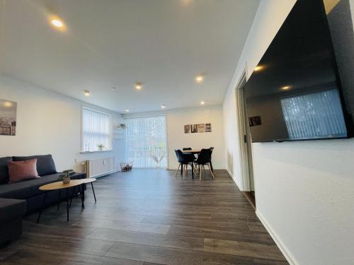 a living room with a couch and a table at aday - Elegant Apartment with Terrace in Svenstrup