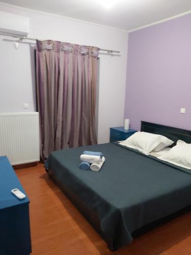 a bedroom with a bed with two towels on it at MARMARI Village in Ayía Marína