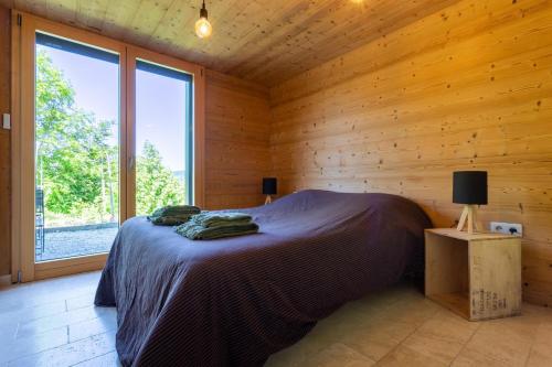 1 dormitorio con 1 cama en una cabaña de madera en Eco-gite Dans Chalet Neuf Au Pied, en Habère-Poche