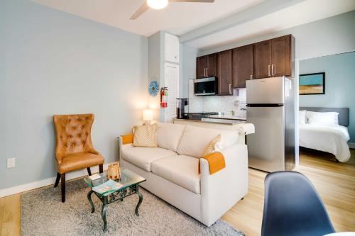 a living room with a couch and a kitchen with a bed at Charming Ocean City Apartment Less Than 1 Mi to Boardwalk! in Ocean City