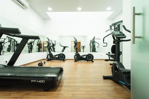 a gym with several treadmills and cardio machines at Magic Tropical Splash in Cala de Finestrat
