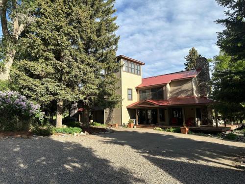 a house with a red roof and a driveway at 3076 W Highway 160 - Combo in Mancos