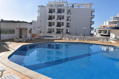 a large swimming pool in front of a building at Varanda para o Mar in Albufeira