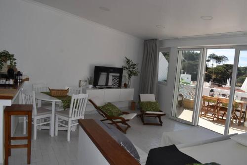 a living room with a couch and chairs and a table at Varanda para o Mar in Albufeira