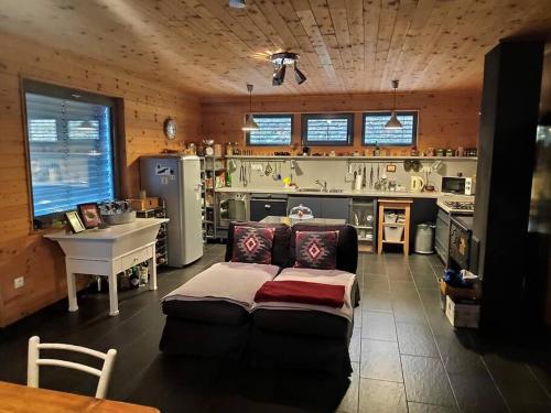 a living room with a couch and a kitchen at St. Barbara Hideaway in Škofja Loka
