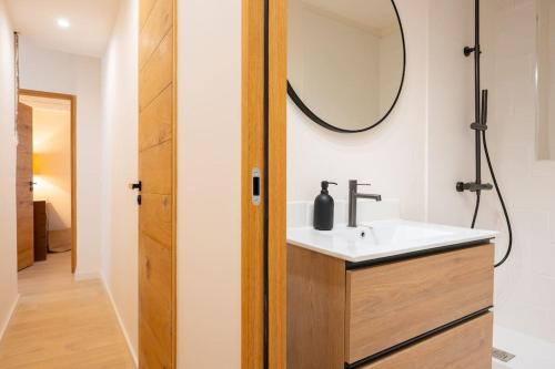 a bathroom with a sink and a mirror at Ile de Porquerolles, KerMarc, appartement lumineux avec grande terrasse in Porquerolles