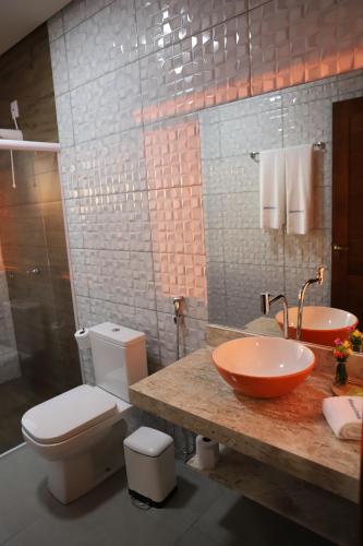 a bathroom with a toilet and a sink at MIRANTE DO CERRADO in Nobres