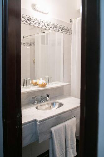a bathroom with a sink and a mirror at Hotel Salta in Salta