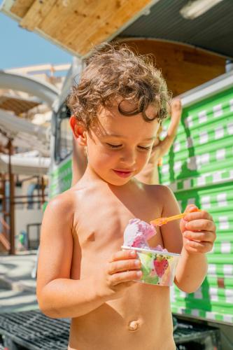 a young boy eating a ice cream with a straw at Magic Tropical Splash in Cala de Finestrat