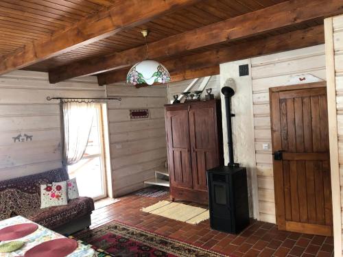 a living room with a wood stove in a room at Buczynowe Chaty in Wysowa-Zdrój