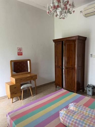 a living room with a tv and a desk at Cozy villa with swimming Pool in Sentul in Bogor