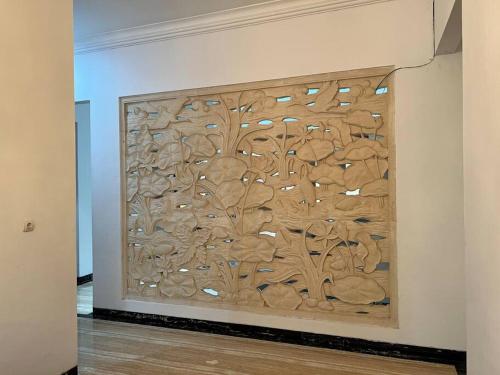 a wall with a wooden carving on a wall at Cozy villa with swimming Pool in Sentul in Bogor