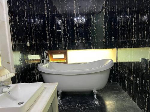 a bathroom with a bath tub and a sink at Cozy villa with swimming Pool in Sentul in Bogor