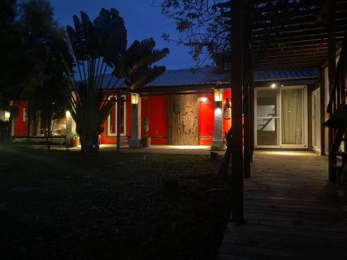 a house lit up at night with red lights at 好和院景 How Has in Chishang