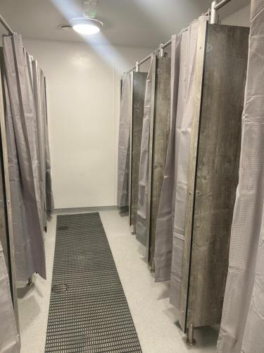 a row of metal stalls in a room at Achill Surf Centre in Mayo