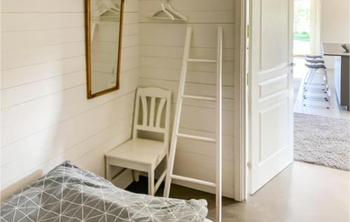 a room with a ladder and a chair at Cozy Home In Lammhult With Sauna in Lammhult