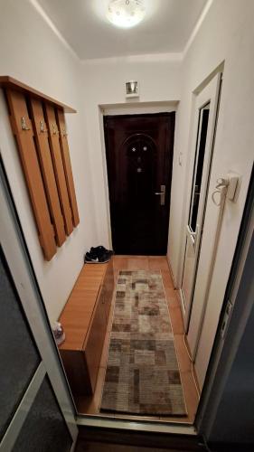 a hallway leading to a black door in a house at Apartament Rareș in Năvodari