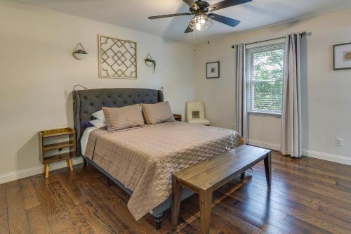 a bedroom with a bed and a ceiling fan at Single-Story Webb City Home with Deck and Gas Grill! in Joplin