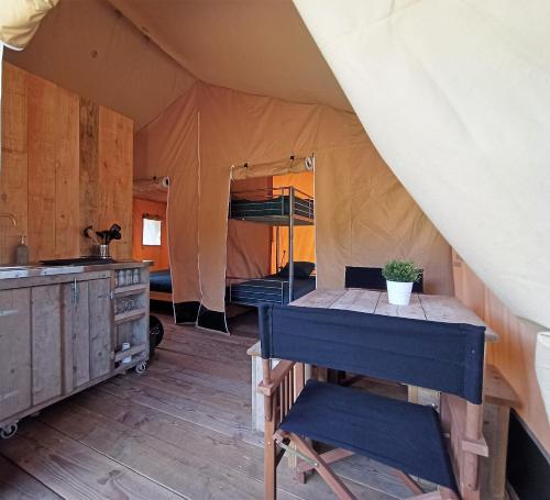 a room with a table in a tent at Le Lodge du Hibou in Quarré-les-Tombes