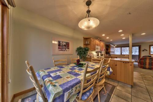 a dining room and kitchen with a table and chairs at Snow Creek Village #20 By Bear Country in Sun Peaks