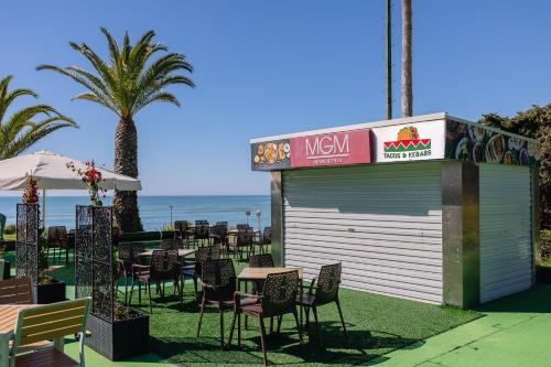 a restaurant with chairs and tables in front of the ocean at Muthu Clube Praia da Oura in Albufeira