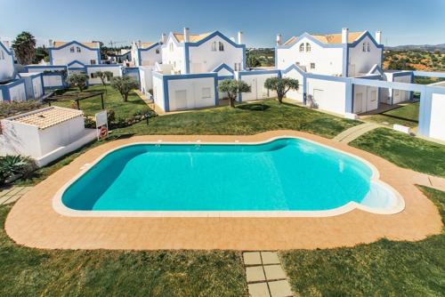 an aerial view of a villa with a swimming pool at Casa Alto do Perogil Tavira-3 bedroom house with pool & free wifi in Tavira