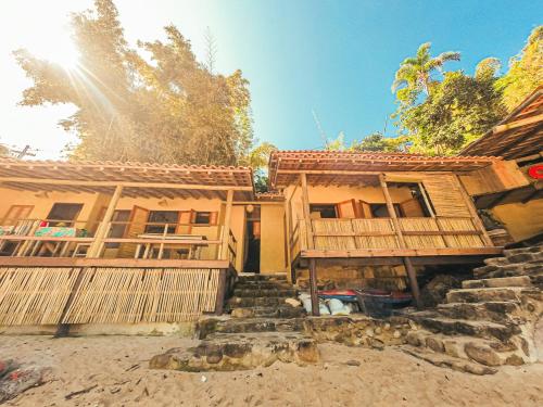 a house with stairs in front of it at Chalé na Praia de Ponta Negra in Ponta Negra