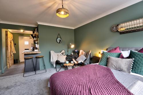 a bedroom with a bed and a living room at Annex by the Sea in Lancing