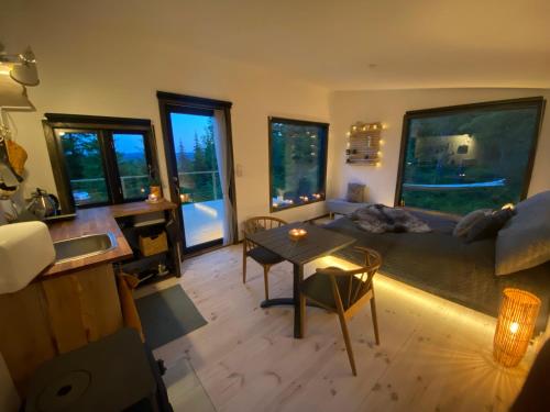 un salon avec un canapé et une table dans l'établissement Forest cabin with stunning mountain view & Sauna, à Torsby
