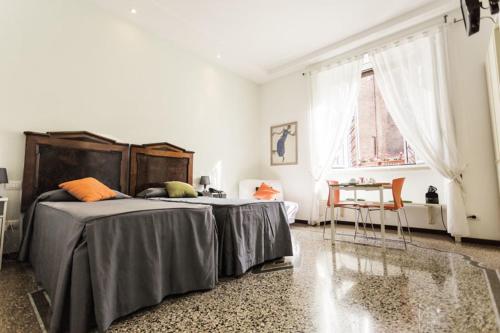 Posteľ alebo postele v izbe v ubytovaní Maison Colosseo (Via dei Querceti 24)