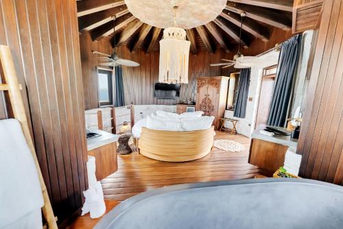 a living room with a bed and a chandelier at The Aerial, BVI in Tortola Island