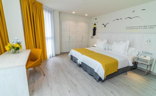 a hotel room with a large bed and a desk at Lemon & Soul Las Palmas in Las Palmas de Gran Canaria