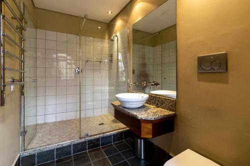 a bathroom with a sink and a shower at Cape Town Heritage Hotel & Spa in Cape Town