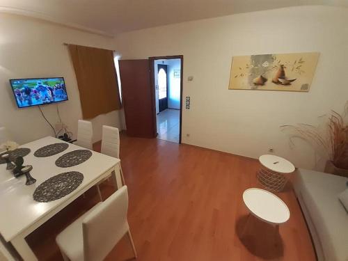 a kitchen and dining room with a table and chairs at APARTMANI DELAS in Pješčana Uvala