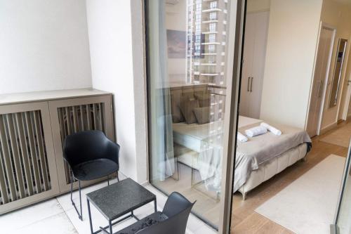 a room with a mirror and a chair and a bed at BW VERDE DREAM in Sajmište