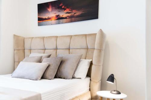 a bedroom with a bed with pillows on it at BW VERDE DREAM in Sajmište