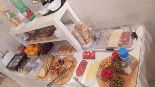 an overhead view of an open refrigerator with lots of food at DONNA LUCREZIA b&b Boutique Hotel Style - relax & business stay in Bisceglie