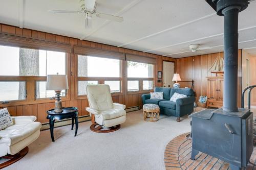 a living room with a stove and chairs at Vibrant Waterfront Vacation Rental on Lake Huron! in Tawas City