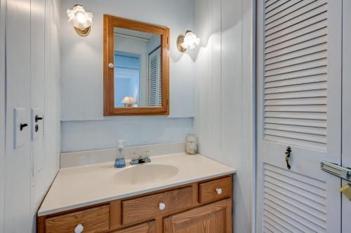 a bathroom with a sink and a mirror at Vibrant Waterfront Vacation Rental on Lake Huron! in Tawas City